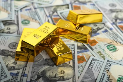 Gold Bars Stacked on US Hundred Dollar Bills/africaimages/Envato