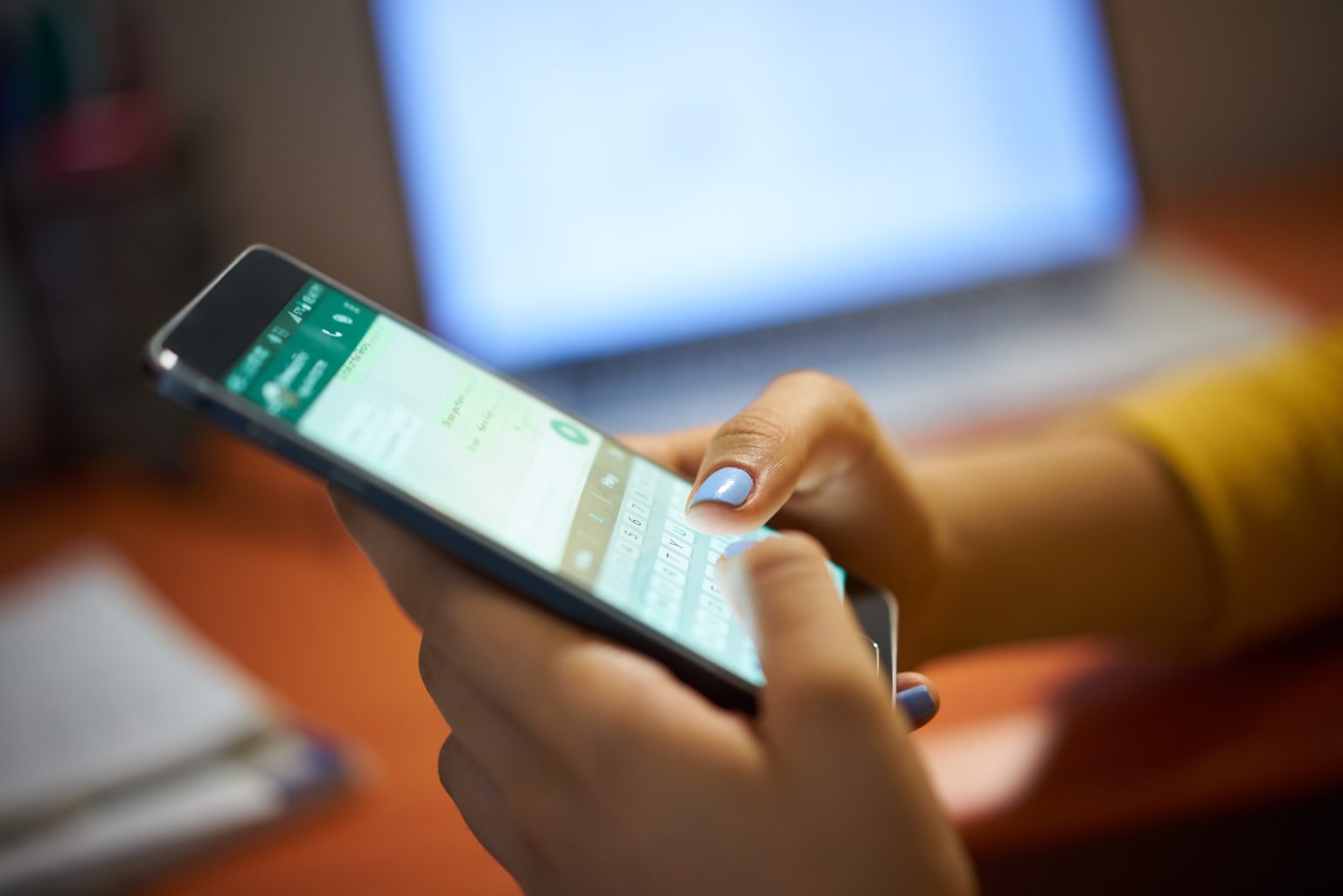 Young woman using cell phone/diego_cervo/Envato