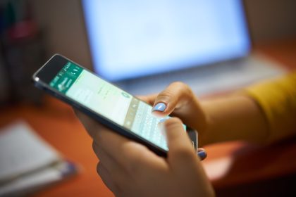 Young woman using cell phone/diego_cervo/Envato