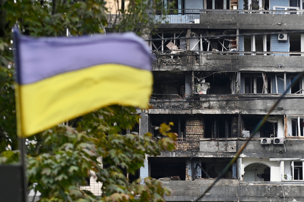 The Ukrainian flag flies against the background of a residential building/Review News/Shutterstock