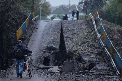 Balakliya, Ukraine - September 28th 2022 - citizens freely move on the city and use the destroyed bridge, after the liberation of the city from Russian occupation on September 8th, 2022 / Shutterstock