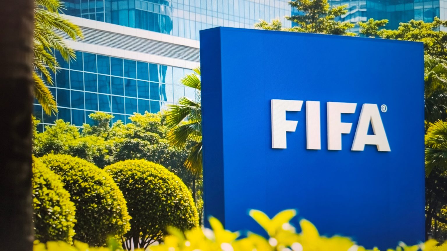 Fifa headquarters in Zurich, Switzerland, with the blue logo sign on a sunny day with green trees - New York City, 17 October 2025