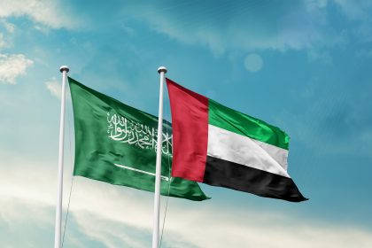 Saudi Arabia and UAE friendship flags are waving in the sky. Double country Flag waving with mast. Saudi Arabian UAE national flag for agreement / Shutterstock