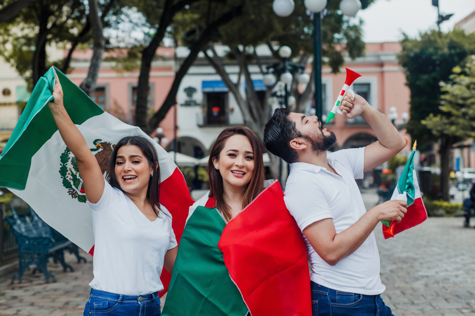 Celebrating with Flags and Horns in a City Square/Light-and-Vision/Envato