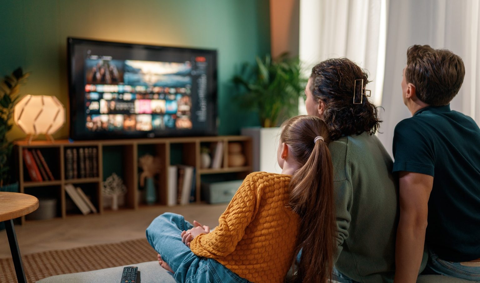 Family Relaxing Together Watching Television at Home