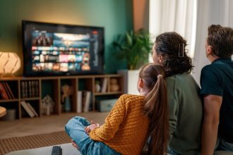 Family Relaxing Together Watching Television at Home