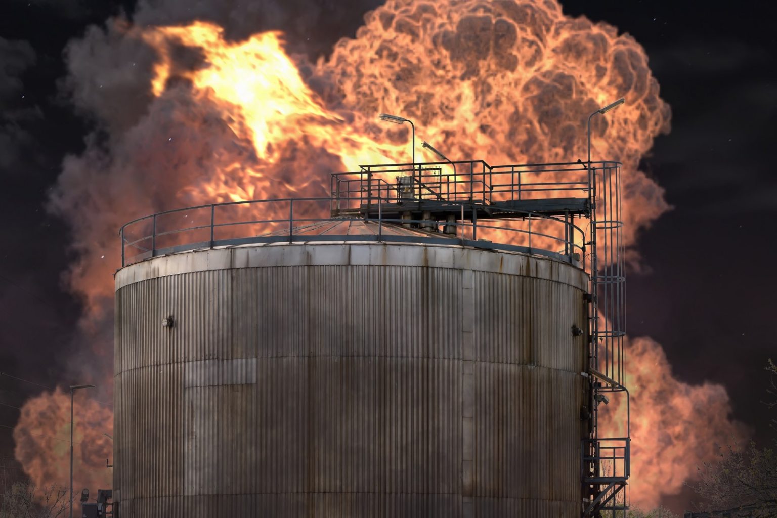 Fire at an oil refinery, a fuel tank is burning and smoking after an explosion/Anelo/Shutterstock