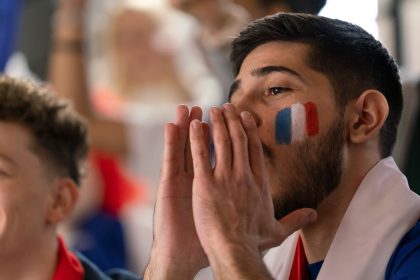 French football fans celebrating their team's victory at stadium/halfpoint/Envato