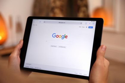 Woman using Google search engine on tablet indoors, closeup/africaimages/Envato