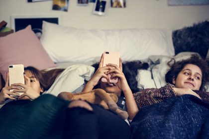 Teenage girls on social media in bed